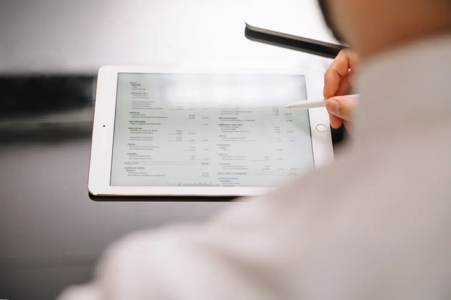 Person reviewing invoice status on a tablet