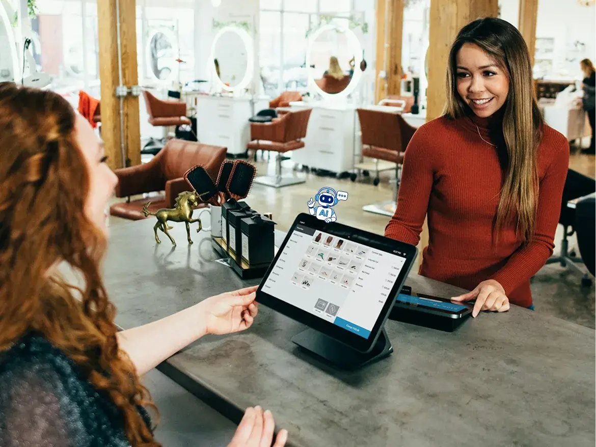 Happy women chatting in a shop where we can see a payment system on the table