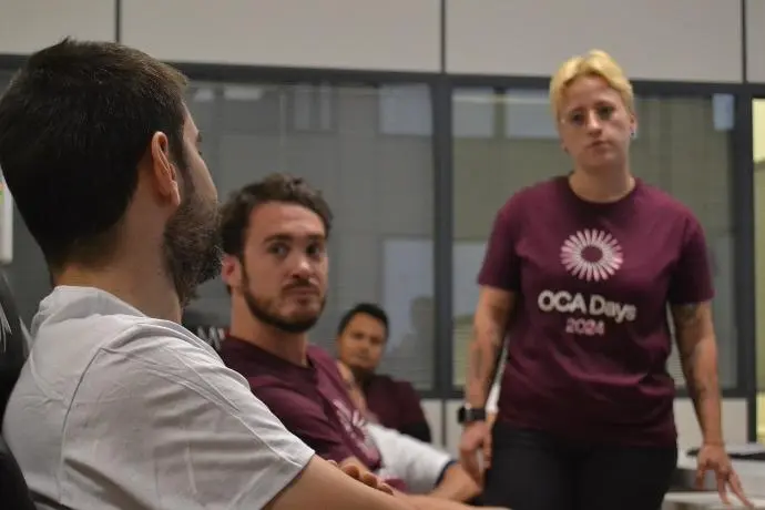 A group of people watching a talk