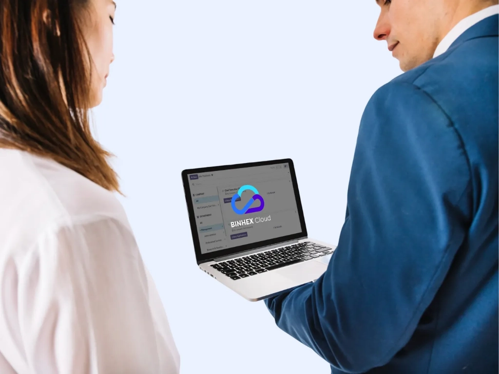 A man and a woman looking at the Binhex Cloud screen on a computer