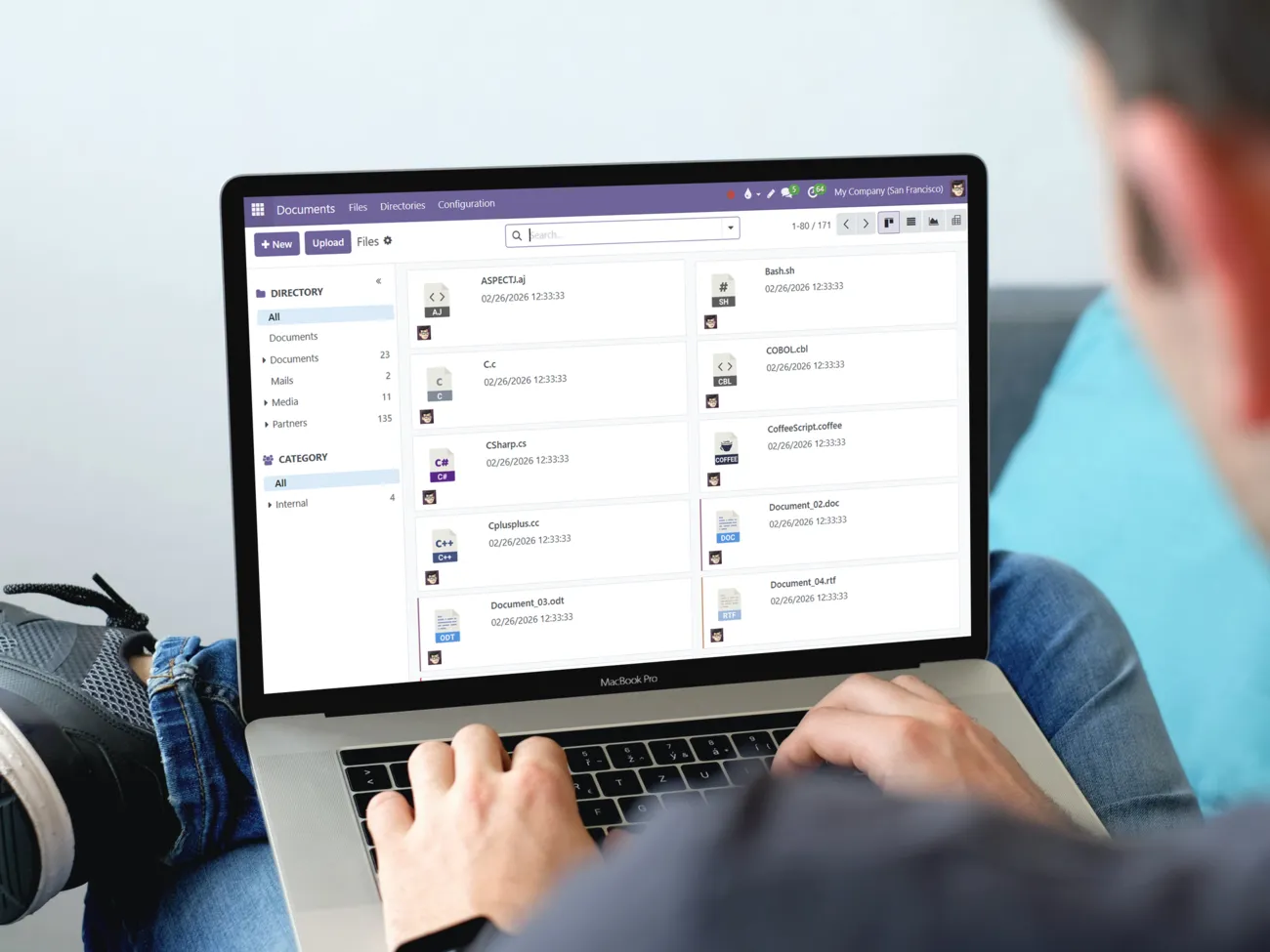 A man using a computer, with the main screen of the Documents app visible