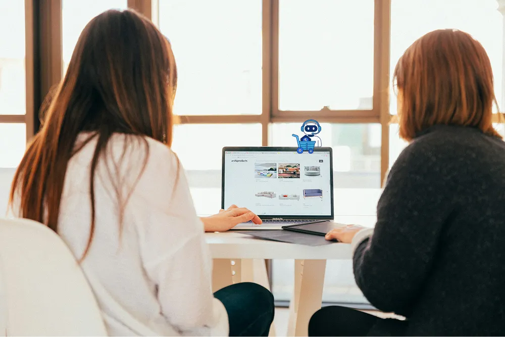 Two women looking at a computer screen displaying a list of products