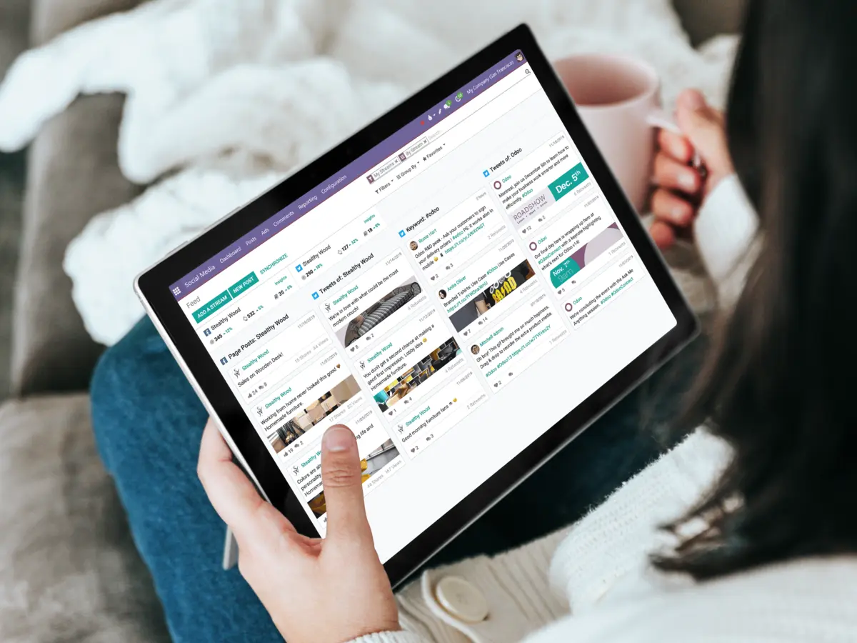 A person drinking coffee and using a social media app on a tablet